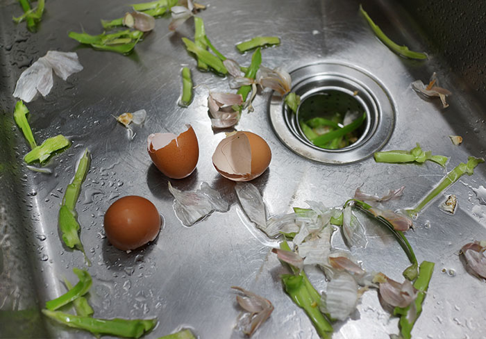 how to prevent blocked drains - kitchen sink full of food scraps