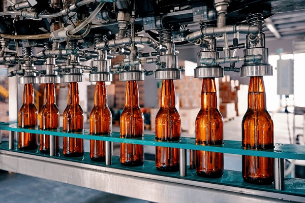 bottles on conveyor belt as example of customer needing trade waste pipe repair